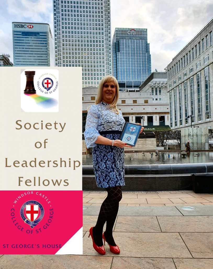 Pips Bunce standing in front of the large buildings on Canary Wharf in London in which she is proudly holding a plaque denoting that she is now an appointed member of the Leadership Fellows at St Georges House Windsor Castle