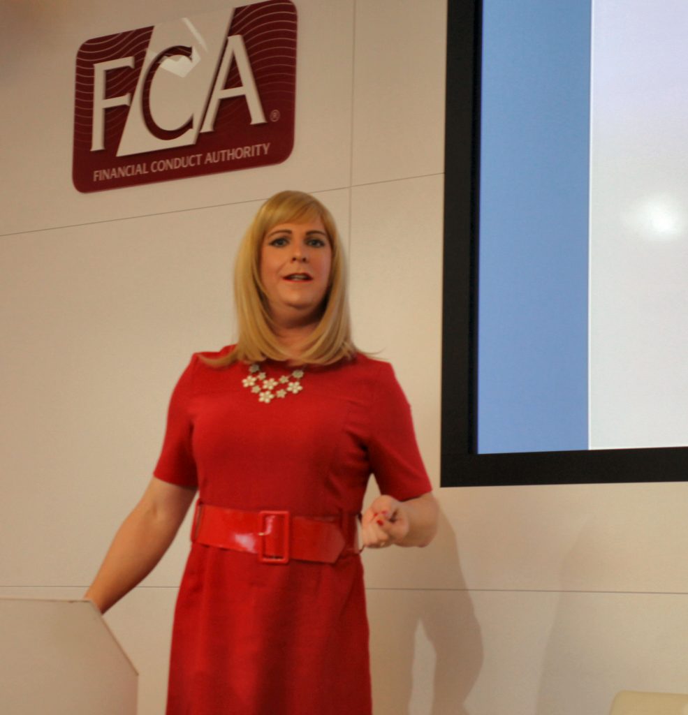 Pips Bunce, founder of Humility Hub, hosting a session,  standing behind a podium at the FCA (Financial Conduct Authority)